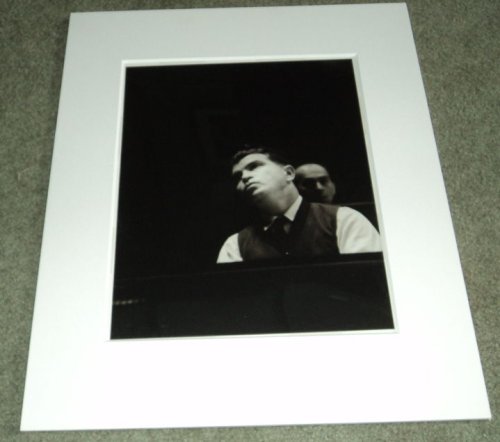 A STUNNING BLACK & WHITE PORTRAIT OF THE GREAT RUSSIAN PIANIST EMIL GILELS SOULFULLY LOOKING UP FROM THE PIANO.