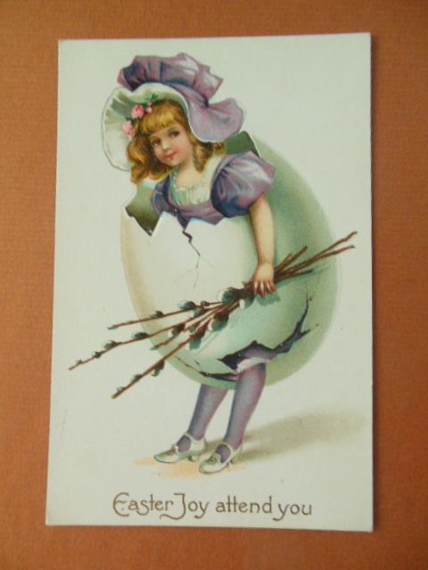 Easter Joy Attend You; Little Girl Breaking out of Egg Holding Pussywillows (postcard)