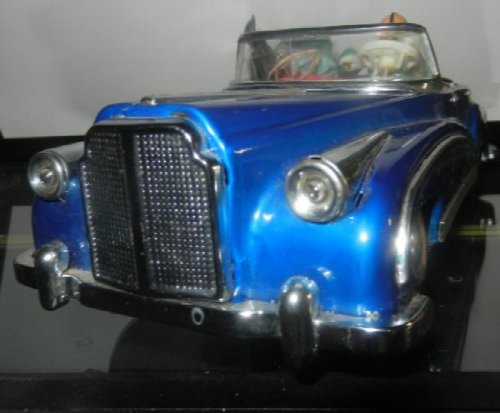 Vintage Photographing on car tin toy